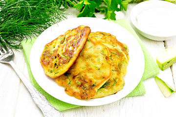 Image showing Pancakes of zucchini on wooden board