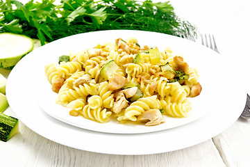 Image showing Fusilli with chicken and zucchini in two plates on board