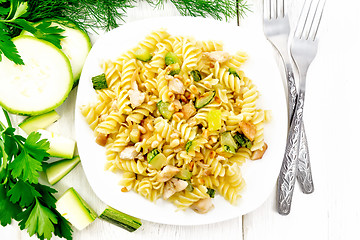 Image showing Fusilli with chicken and zucchini in plate on board top