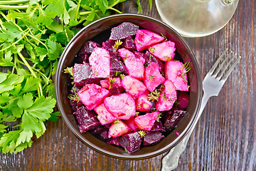 Image showing Salad of beets and potatoes in bowl on dark board top