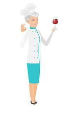 Image showing Chef holding glass of wine and showing ok sign.