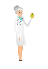 Image showing Caucasian nutritionist offering fresh red apple.