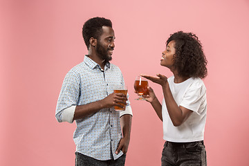 Image showing The afro couple or happy young people laughing and drinking beer at studio