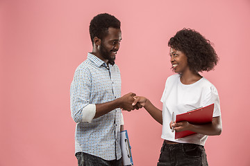 Image showing Two african students with folders in t-shirts together. Stylish girl with Afro hairstyle and her boyfriend.