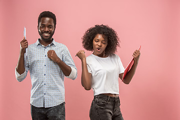 Image showing Two african students with folders in t-shirts together. Stylish girl with Afro hairstyle and her boyfriend.