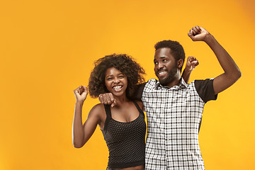 Image showing Winning success couple celebrating being a winner. Dynamic energetic image of afro models