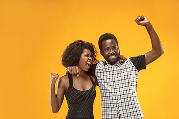 Image showing Winning success couple celebrating being a winner. Dynamic energetic image of afro models