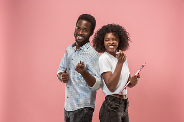 Image showing Two african students with folders in t-shirts together. Stylish girl with Afro hairstyle and her boyfriend.