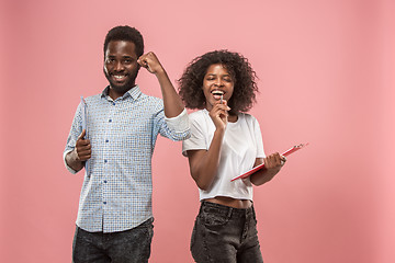 Image showing Two african students with folders in t-shirts together. Stylish girl with Afro hairstyle and her boyfriend.