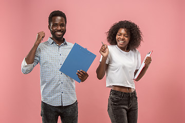 Image showing Two african students with folders in t-shirts together. Stylish girl with Afro hairstyle and her boyfriend.