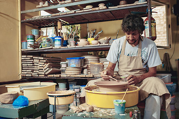 Image showing Creating a jar or vase of white clay close-up. Master crock.