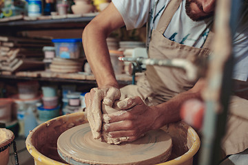 Image showing Creating a jar or vase of white clay close-up. Master crock.