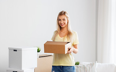 Image showing happy woman with boxes moving to new home