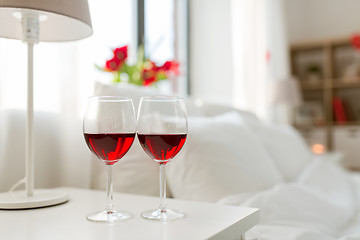 Image showing two glasses of wine on bedroom nightstand at home