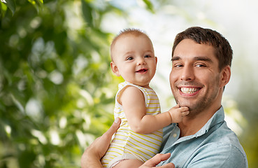 Image showing happy father holding little baby daughter at home