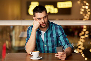 Image showing man with coffee and smartphone at restaurant