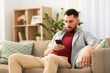 Image showing man using smartphone at home