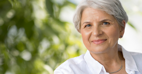 Image showing portrait of senior woman over natural background