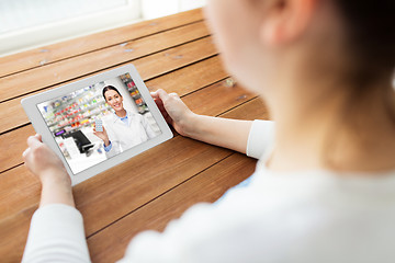 Image showing woman having video chat with pharmacist on tablet