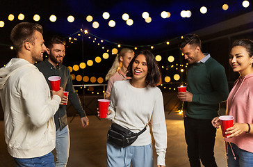 Image showing friends with drinks dancing at rooftop party