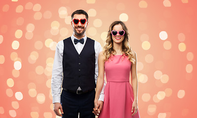 Image showing happy couple in heart-shaped sunglasses