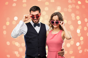 Image showing happy couple in heart-shaped sunglasses