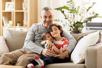 Image showing happy father with preteen and baby son at home