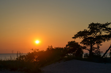 Image showing Sunset with a colorful orange sky by the coast