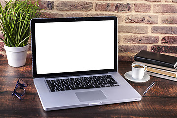 Image showing Laptop notebook with blank screen and cup of coffee and notepad 