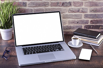 Image showing Laptop notebook with blank screen and cup of coffee and notepad 