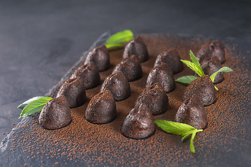 Image showing Homemade chocolate truffles with mint sprinkled with cocoa powde