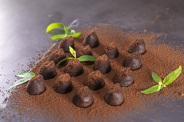 Image showing Homemade chocolate truffles with mint sprinkled with cocoa powde