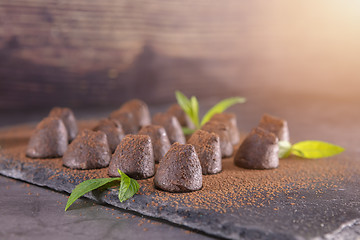 Image showing Homemade chocolate truffles with mint sprinkled with cocoa powde