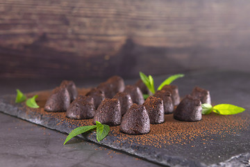 Image showing Homemade chocolate truffles with mint sprinkled with cocoa powde