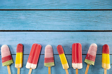 Image showing Ice cream stick placed on a blue vintage wooden