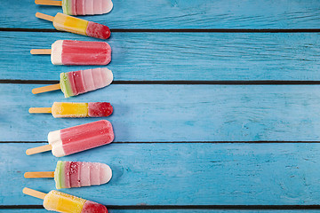 Image showing Colorful fruit ice cream stick look fresh to eat placed on a blu