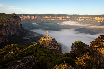 Image showing Hiker taking in magnificent views of mountains and valleys as th