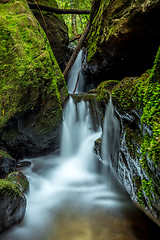 Image showing Waterfall through the rock chasm in mountain gully 