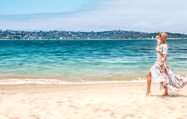 Image showing Woman in flowing dress on beach in Sydney Australia