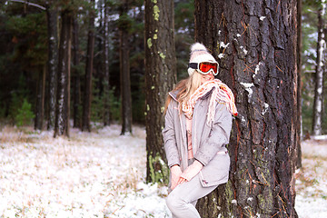 Image showing Woman in a snowy woodland of pine trees