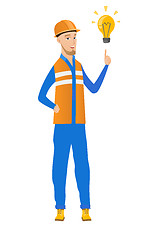 Image showing Young caucasian builder pointing at lightbulb.