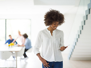 Image showing Portrait of  black casual businesswoman using tablet  with cowor