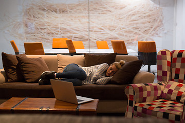 Image showing woman sleeping on a sofa  in a creative office