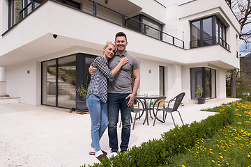 Image showing couple hugging in front of  new luxury home