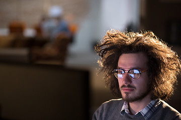 Image showing man working on computer in dark office