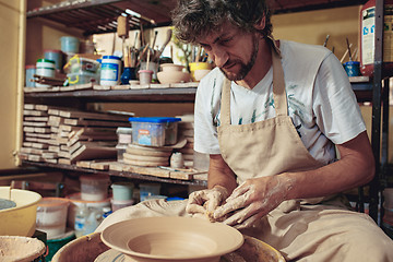 Image showing Creating a jar or vase of white clay close-up. Master crock.