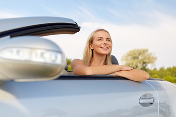 Image showing happy young woman in convertible car