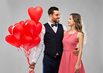 Image showing happy couple with red heart shaped balloons