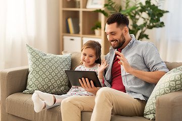 Image showing father and daughter having video call on tablet pc