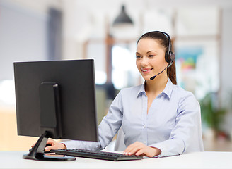 Image showing helpline operator in headset working at office